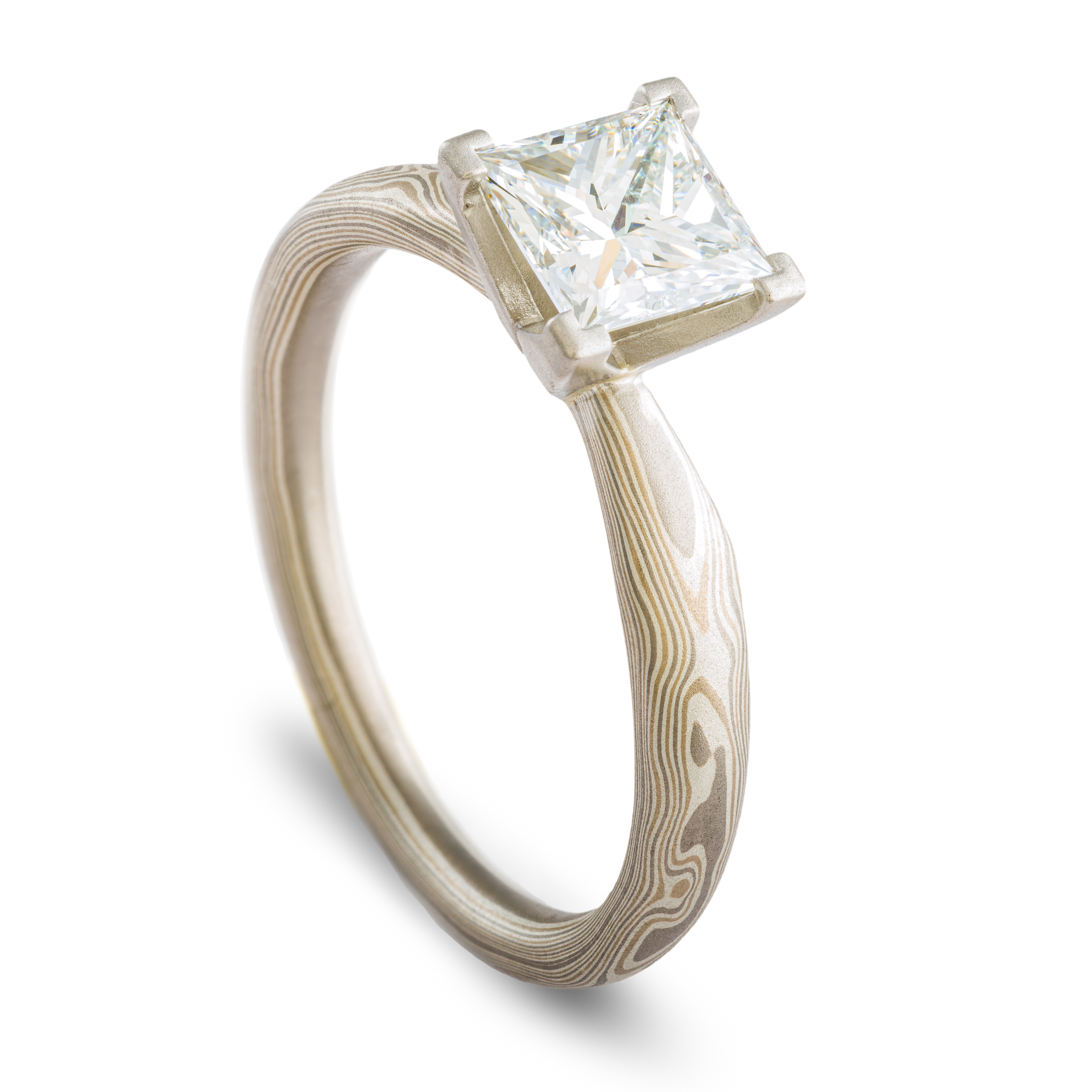 solitaire style mokume gane engagement ring with square diamond set in prongs, ring has an overall silvery palette and a woodgrain style