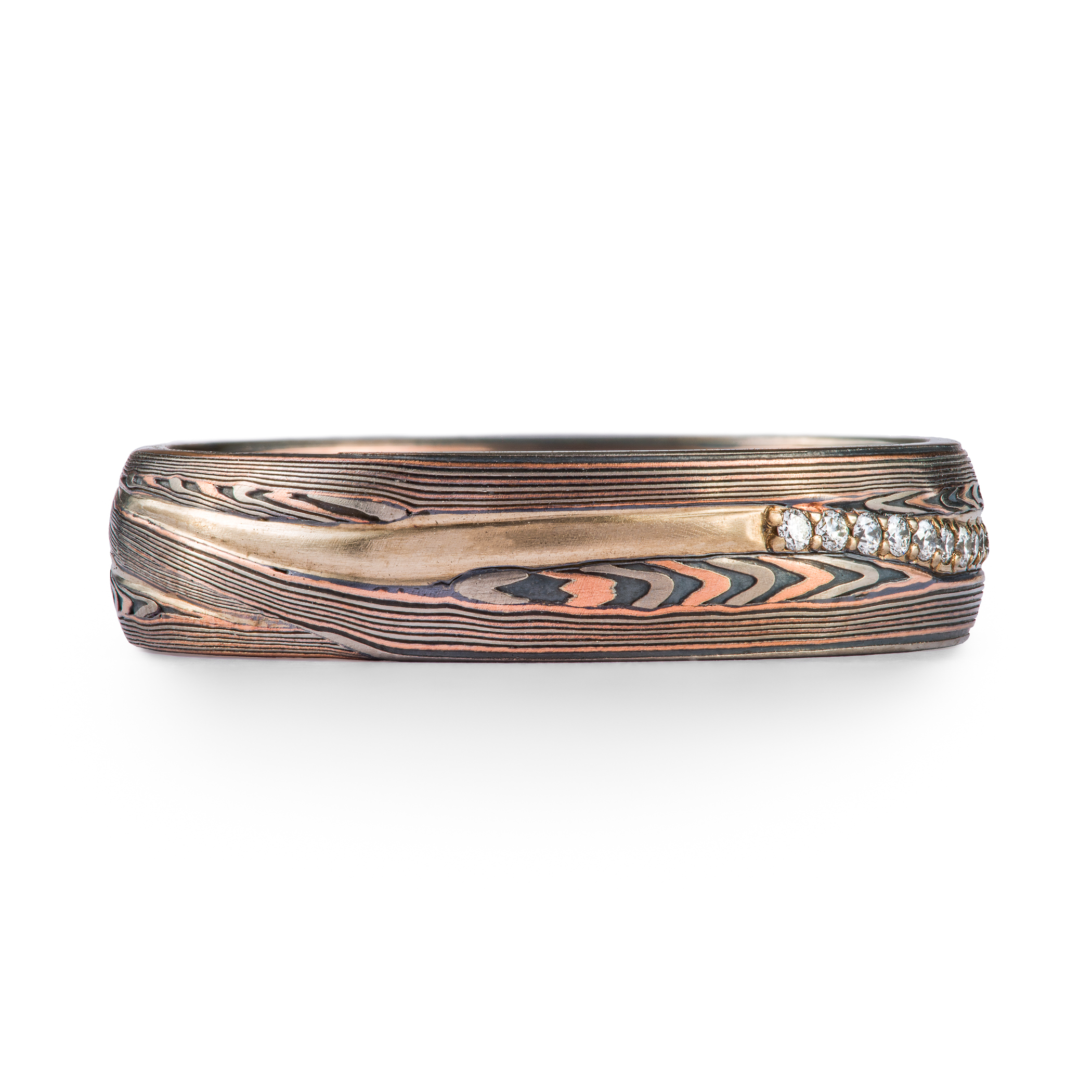 mokume gane patterned ring, red gold palladium and oxidized silver, with a line of diamonds set in the center of the band. The line gently curves around the patterning.