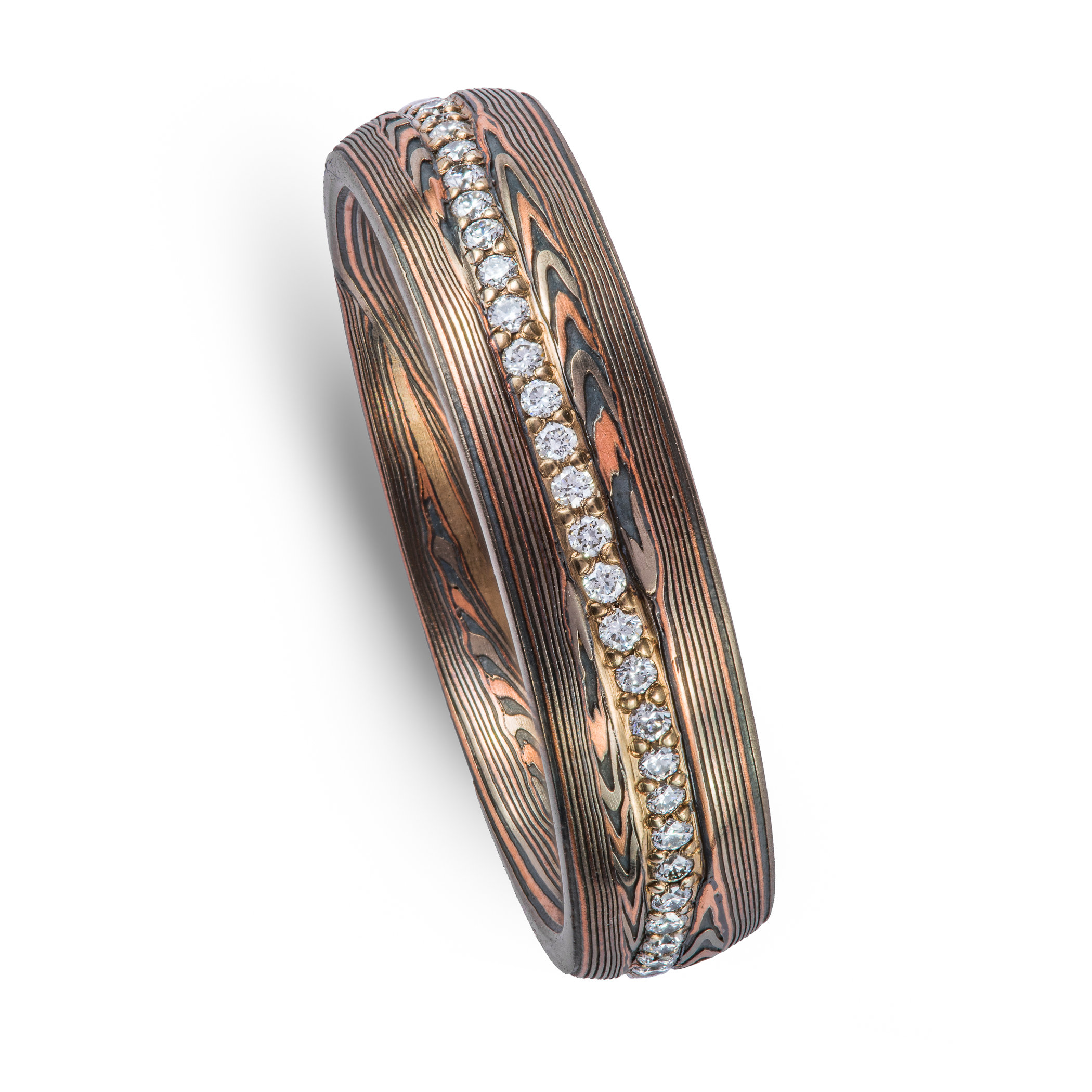 mokume gane patterned ring, red gold palladium and oxidized silver, with a line of diamonds set in the center of the band. The line gently curves around the patterning.