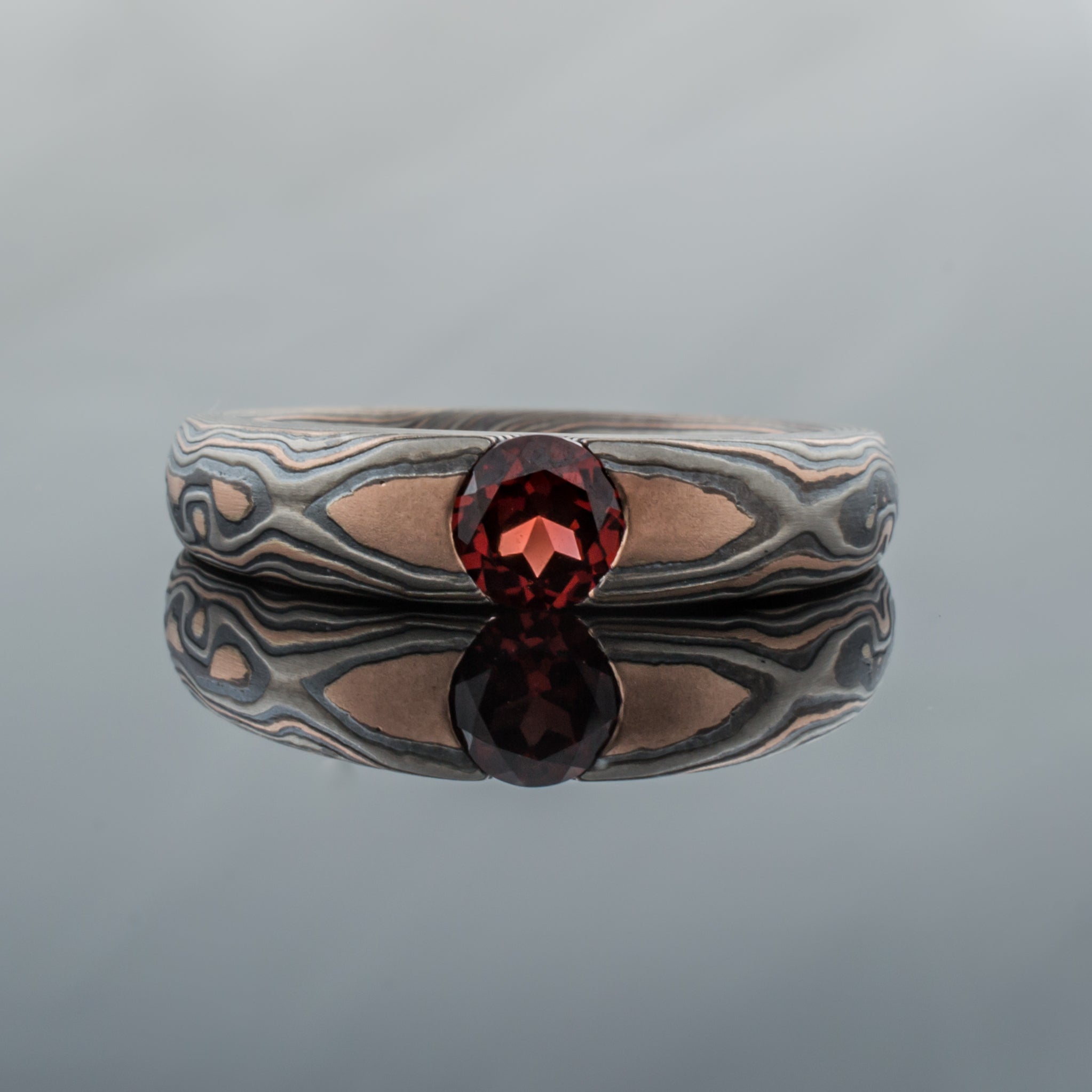 Mokume Gane Ring or Engagement band Ring in oxidized black silver gray palladium garnets red stone center alternative metal nature inspired rustic artisan topographical earthy style