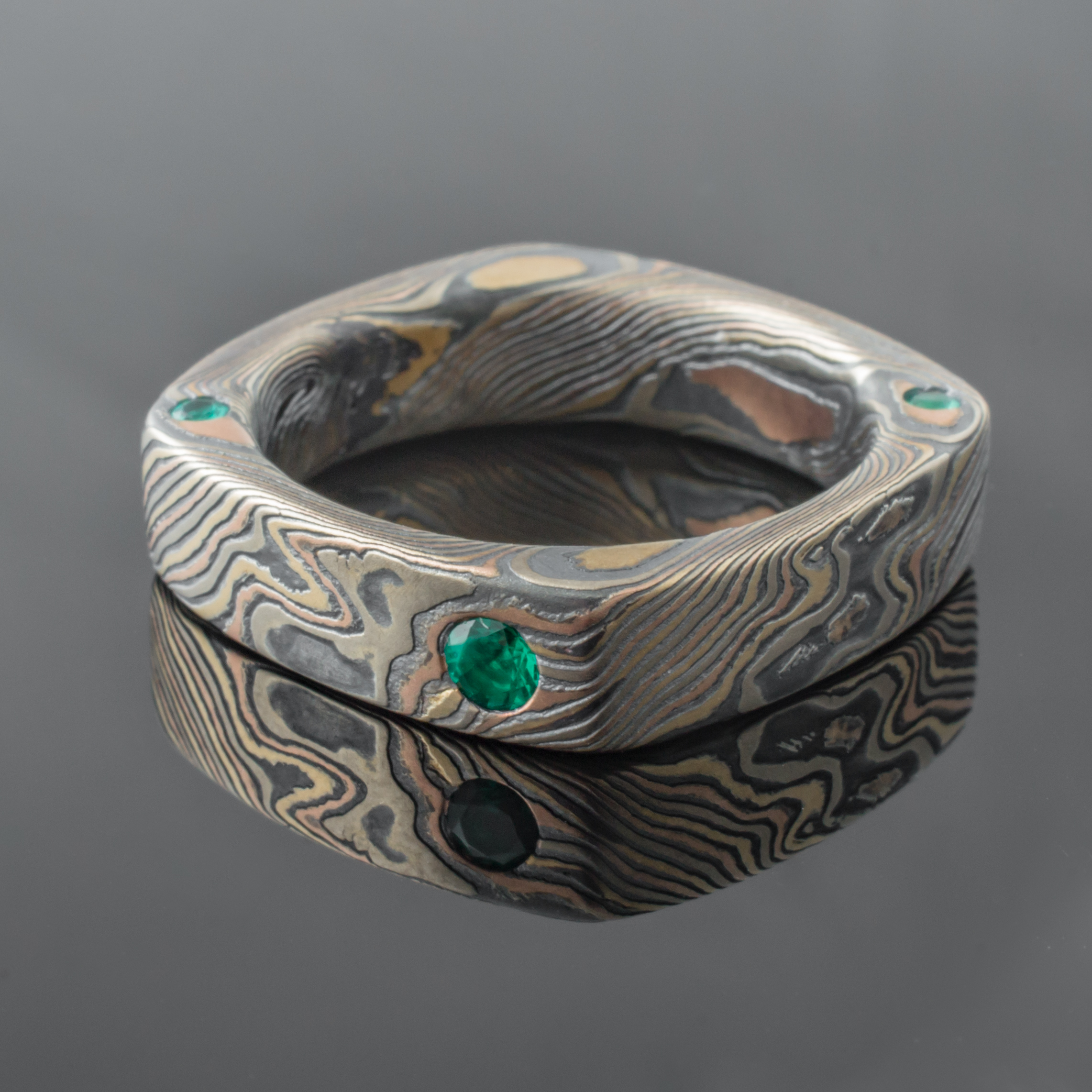 Mokume Square Ring Mens Wedding Band with round, flush set emerald. Artisan, nature inspired, handcrafted, organic, contemporary style.