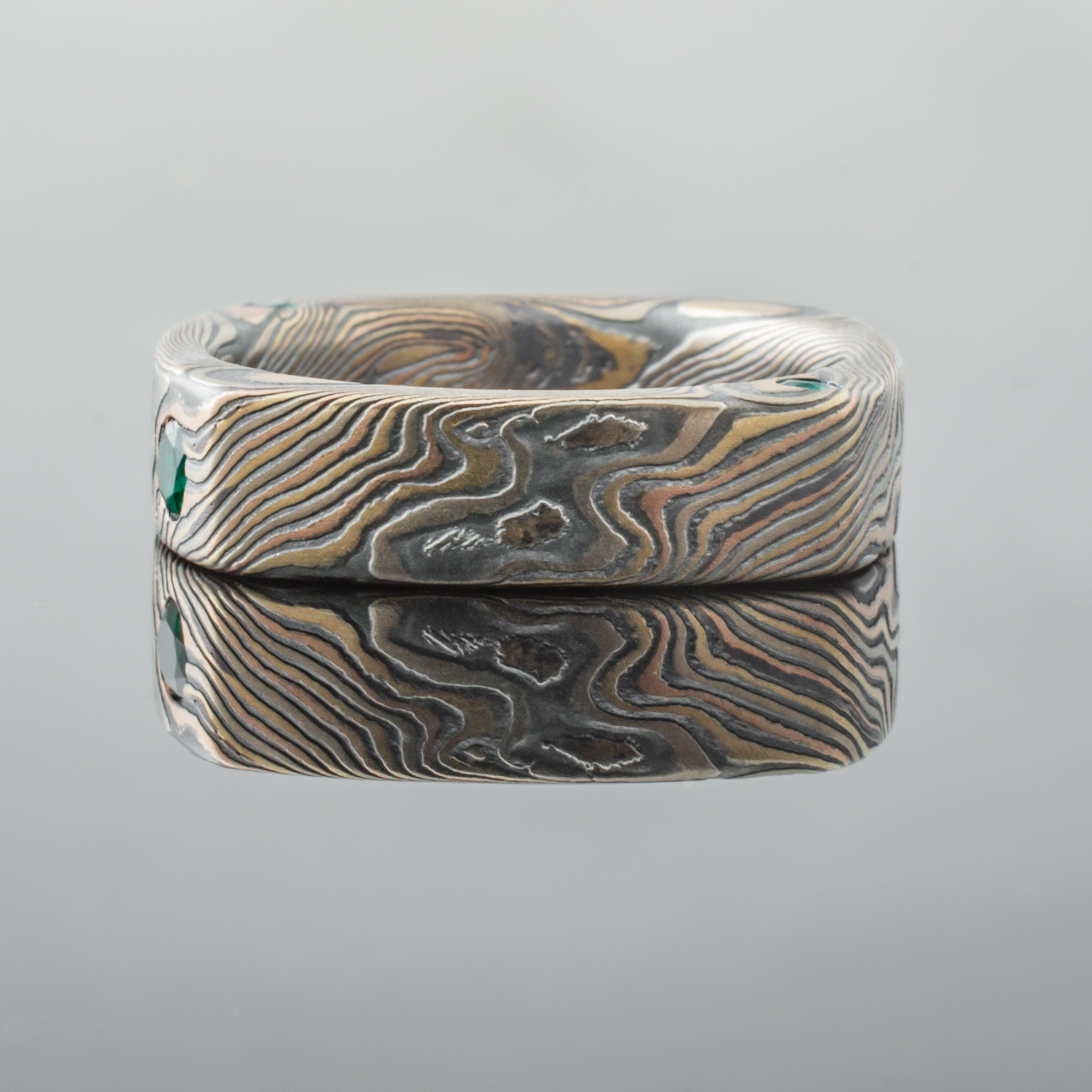 Mokume Square Ring Mens Wedding Band with round, flush set emerald. Artisan, nature inspired, handcrafted, organic, contemporary style.