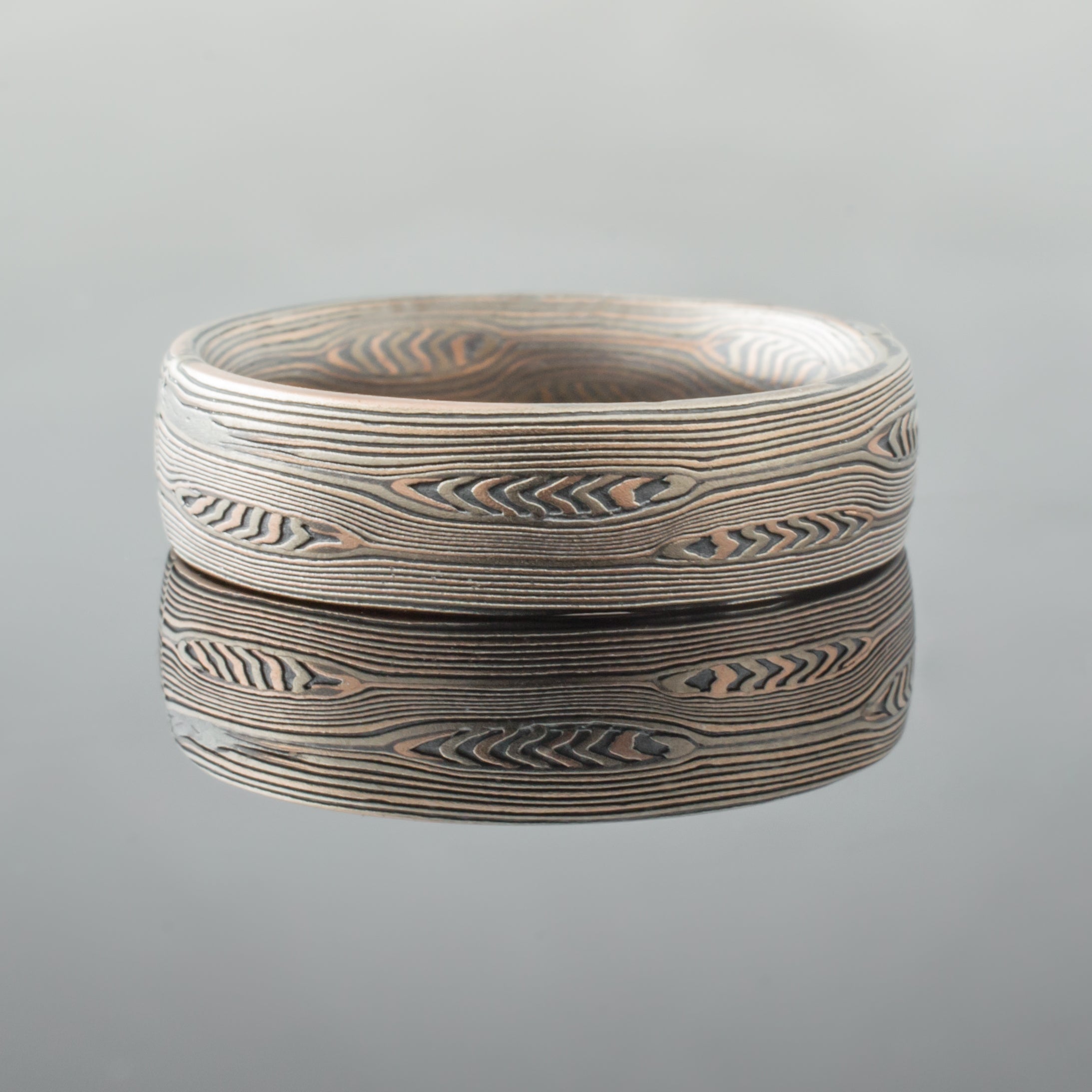mokume ring mens wedding band silver gray mokume gane black mixed metal two tone two-toned artisan crafted nature inspired handcrafted organic contemporary modern earthy topographical multicolor metal white gold oxidized sterling silver pattern tree rings
