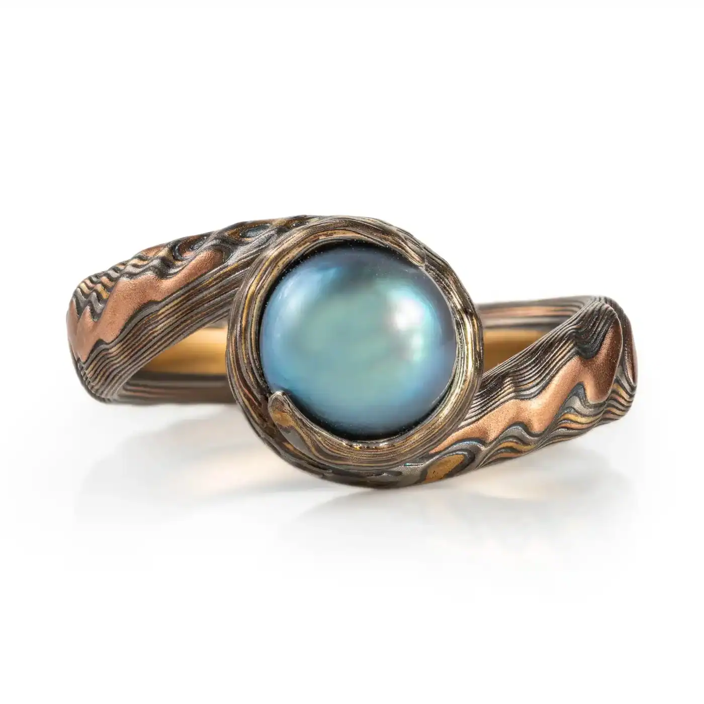 bypass style mokume gane ring, made in custom version of arn krebs guri bori pattern, inspired by the ocean and made to look like the texture of oyster shell, the band curls around a blue pearl