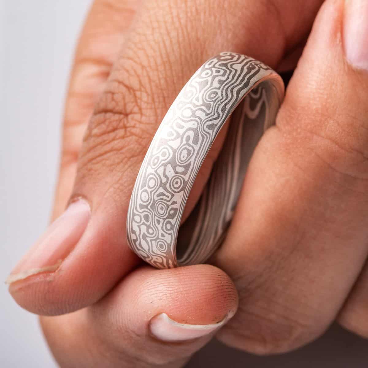 smooth finished, domed, mokume gane ring made with silver and palladium in a twist and droplet combination pattern