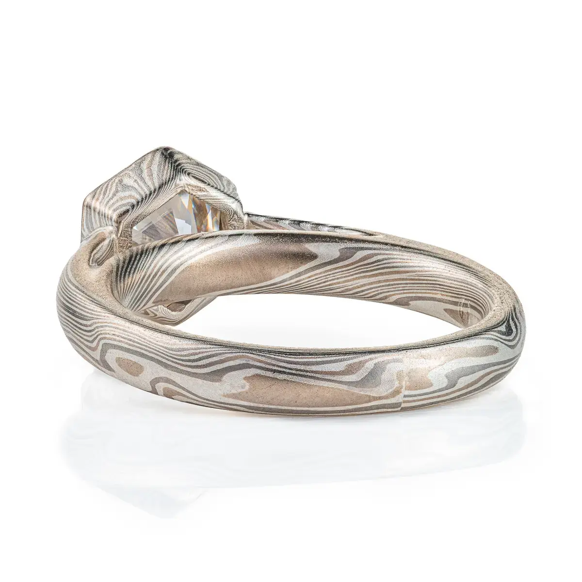 beautiful mokume gane ring with hexagon shaped moissanite in a floating mokume bezel with a light silvery palette