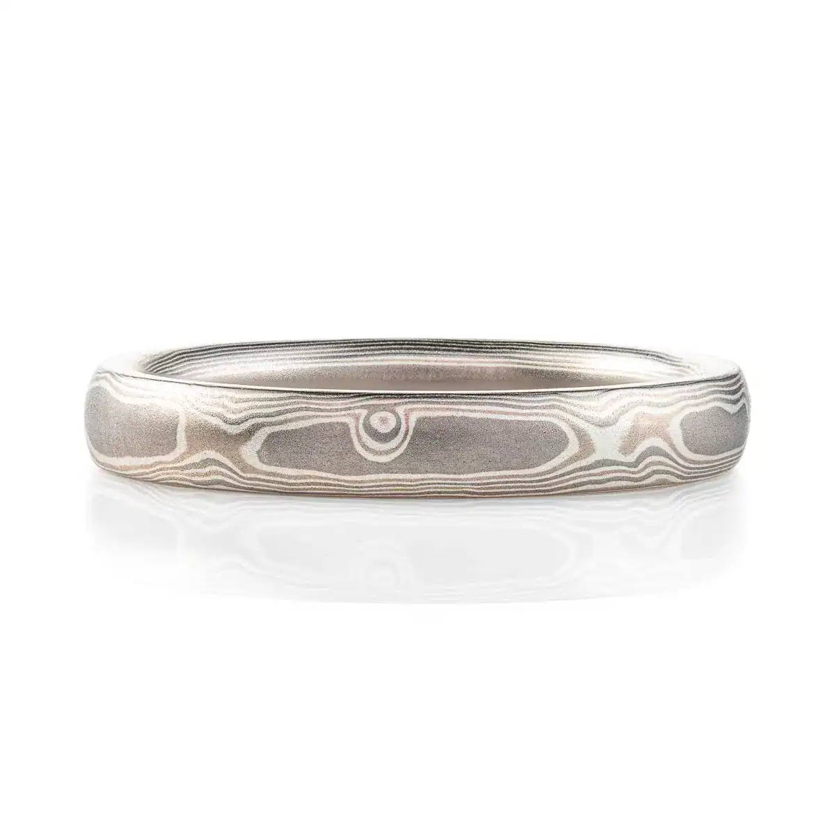 mokume gane band patterned to resemble woodgrain, in a silver looking palette with metals of different shades