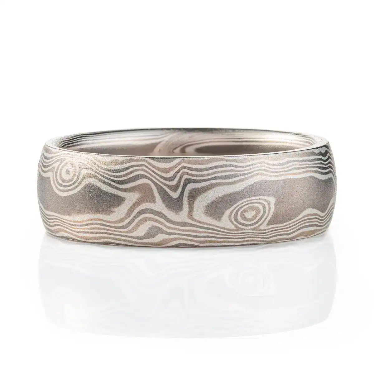 mokume gane band patterned to resemble woodgrain, in a silver looking palette with metals of different shades