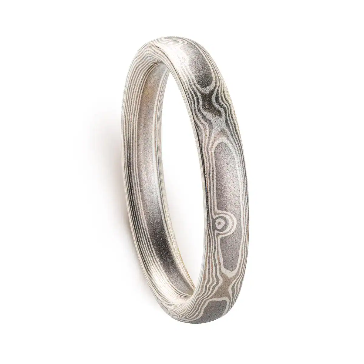mokume gane band patterned to resemble woodgrain, in a silver looking palette with metals of different shades