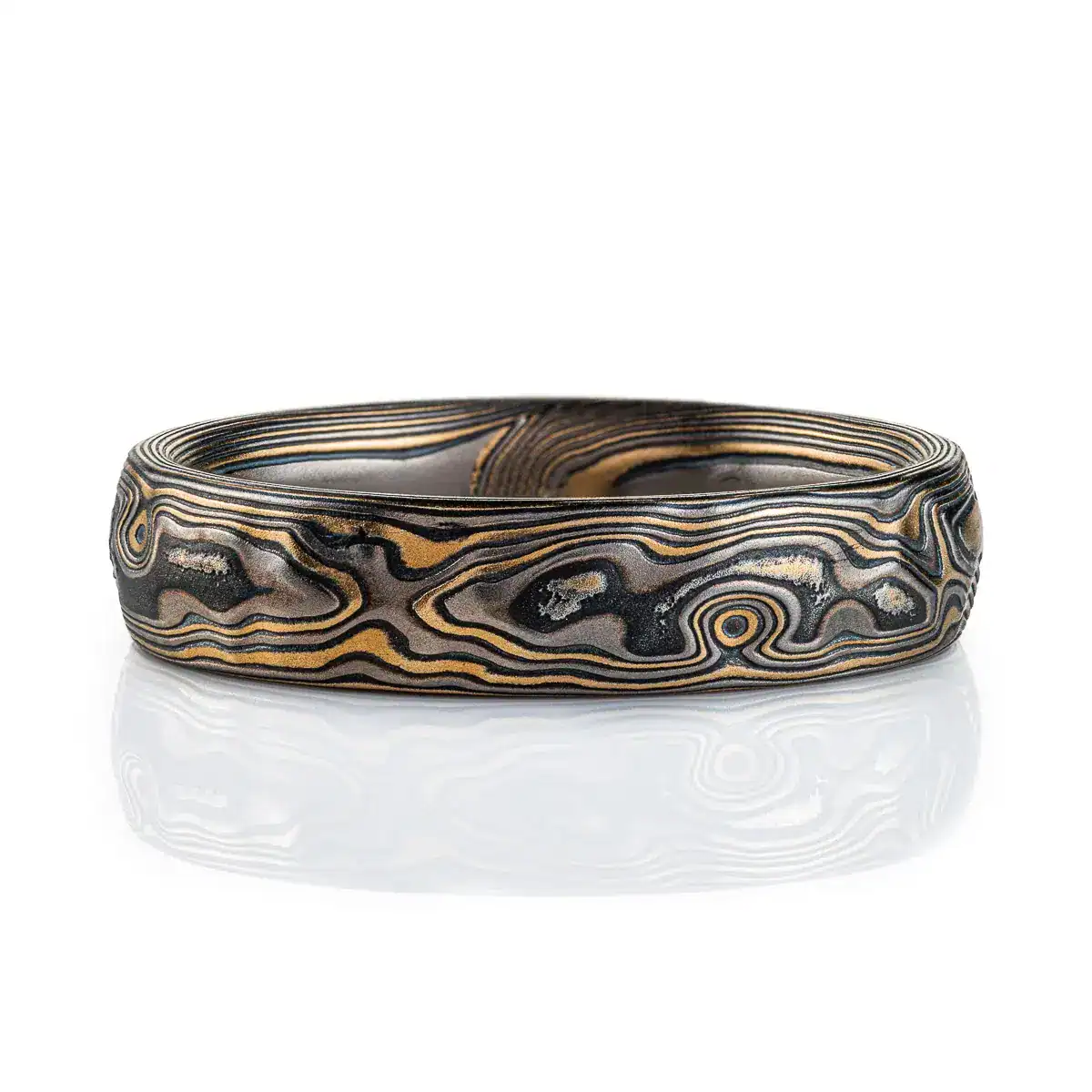 mokume gane woodgrain patterned ring with etched and textured finish, made with yellow gold, palladium and oxidized silver