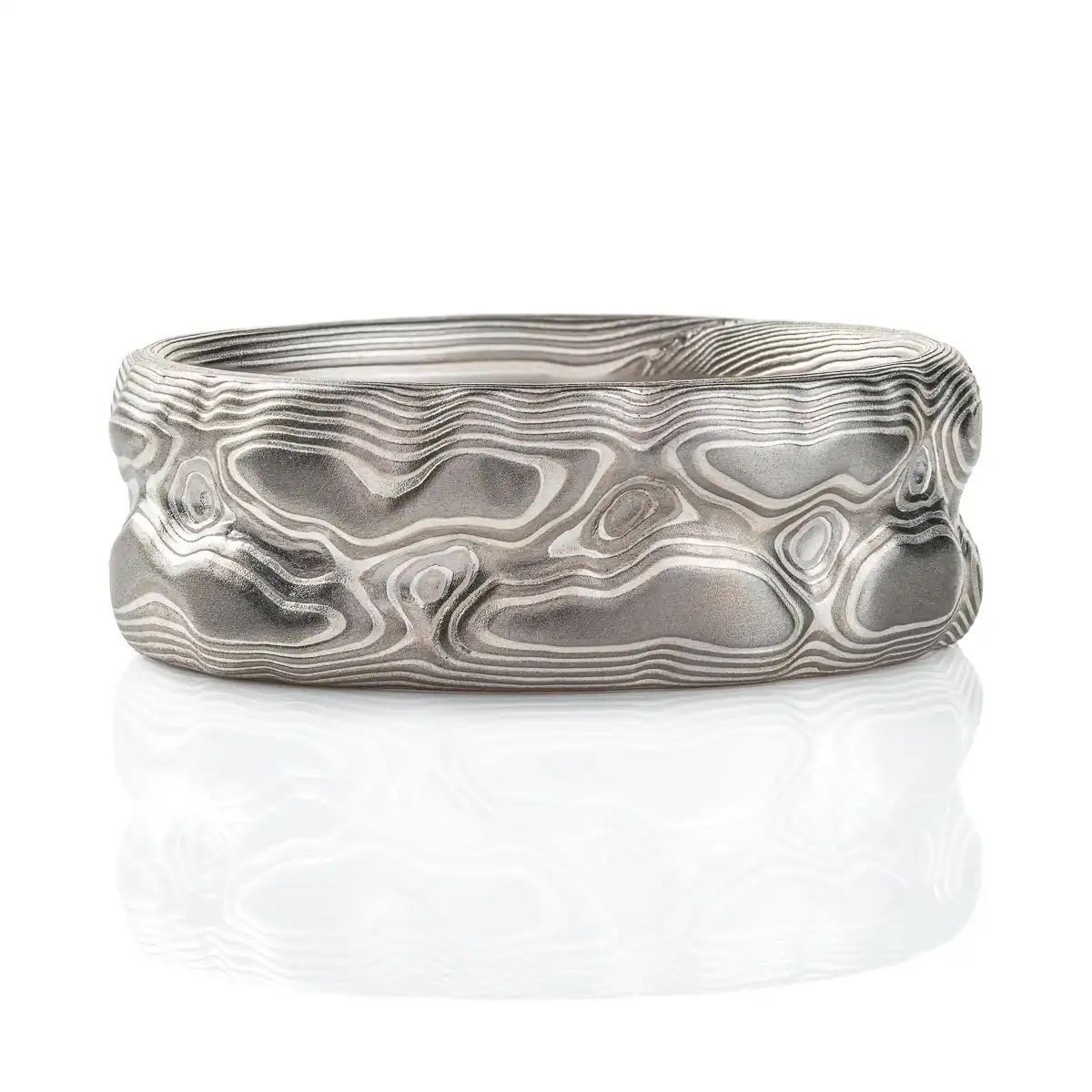 Ring patterned in a topographic style that resembles rocks and mountains, silver and light gray color combination.