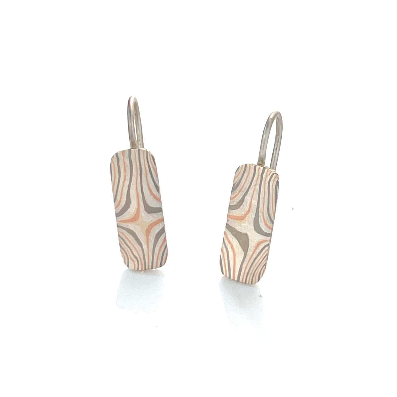 rounded rectangular dangle style earrings, patterned in a way to resemble a star