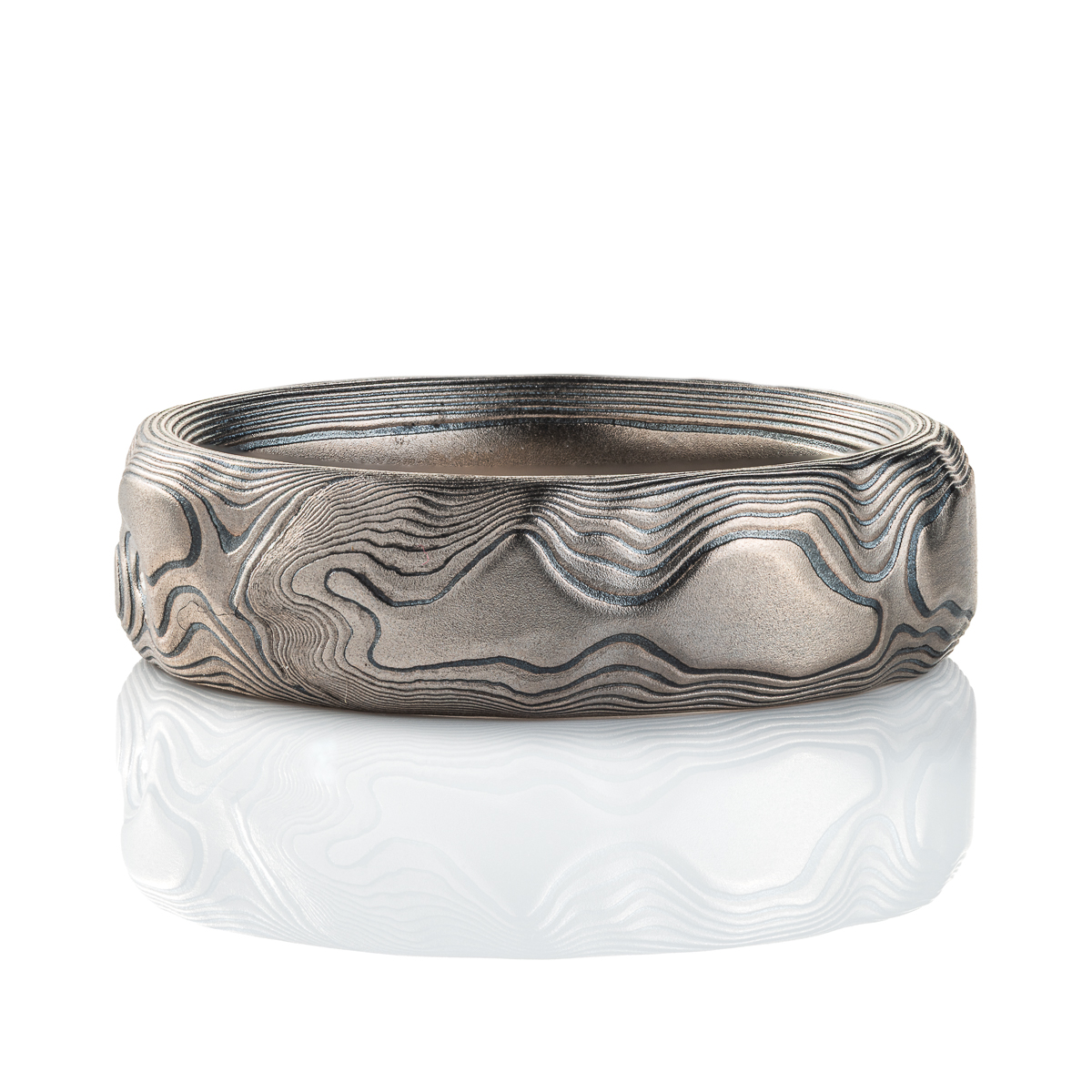 Gray and black mokume gane patterned ring, made to look like topographic/rock texture.