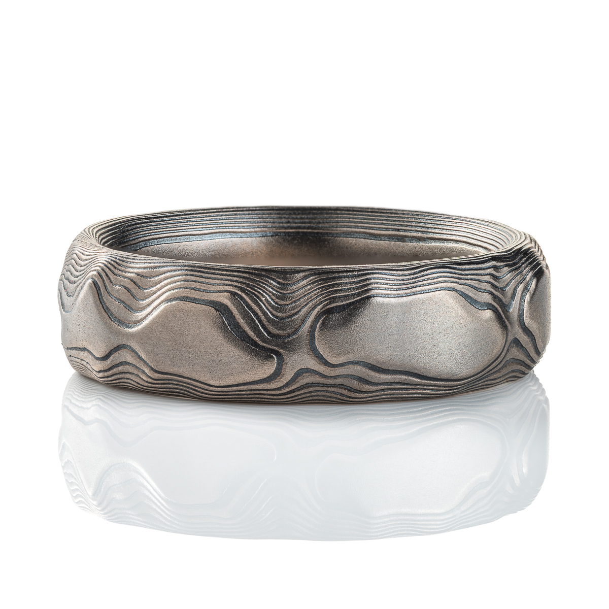 Gray and black mokume gane patterned ring, made to look like topographic/rock texture.