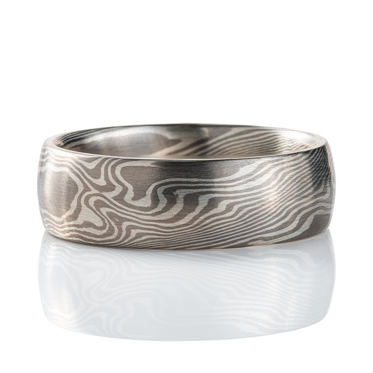 Wide mokume gane patterned ring, domed profile, made with light and dark gray metals.
