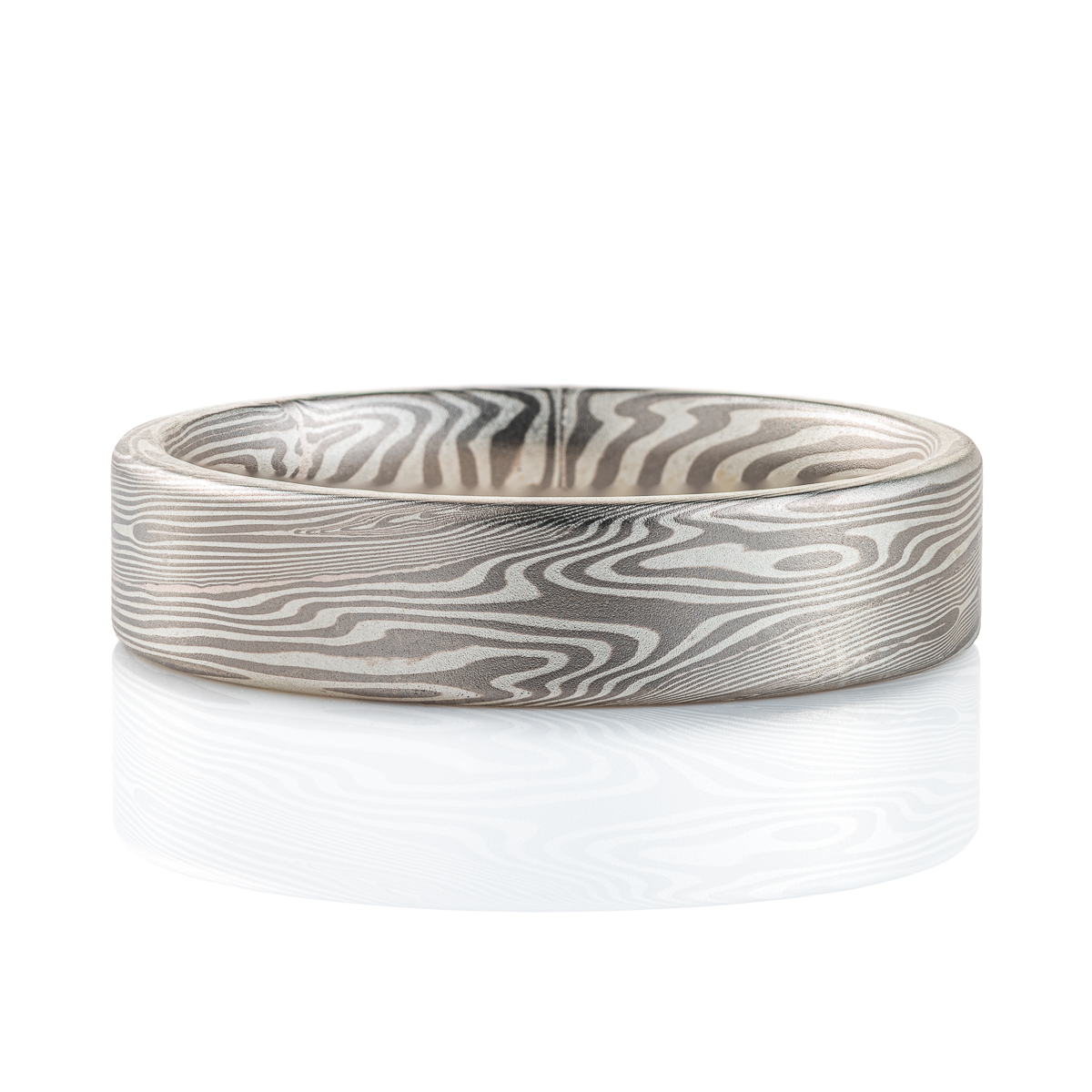 Narrow, flat profile band, mokume gane pattern in a linear style, made with palladium and silver for an overall silvery/gray color palette.