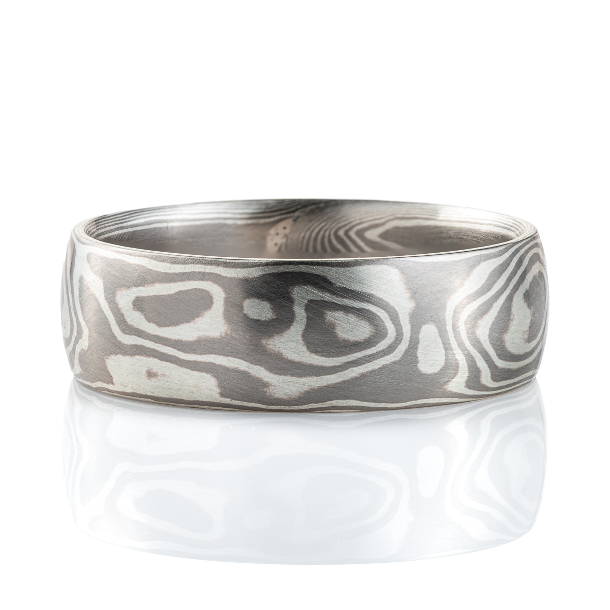 Smooth, domed ring, made in a mokume gane woodgrain pattern, in a combination of palladium and sterling silver.
