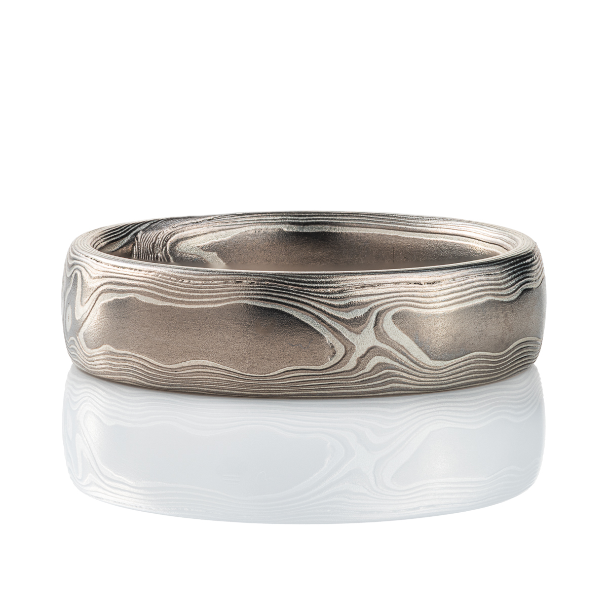Mokume gane band patterned to resemble woodgrain, made with layers of palladium and silver.