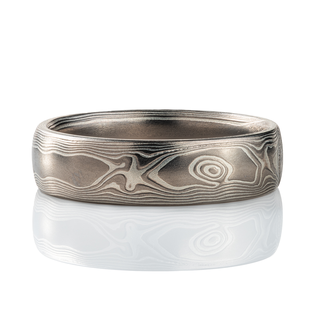Mokume gane band patterned to resemble woodgrain, made with layers of palladium and silver.