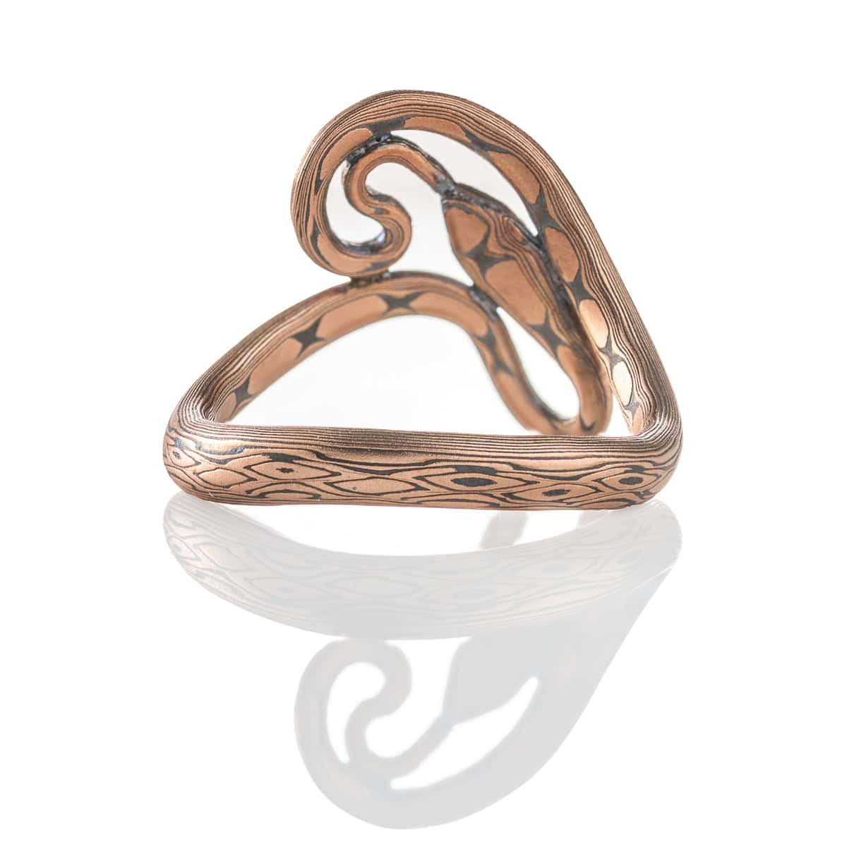 Custom handcrafted and forged mokume gane ring made to look like a snake curling and twisting around the finger. Made with red gold and oxidized silver, with tiny diamonds as eyes.