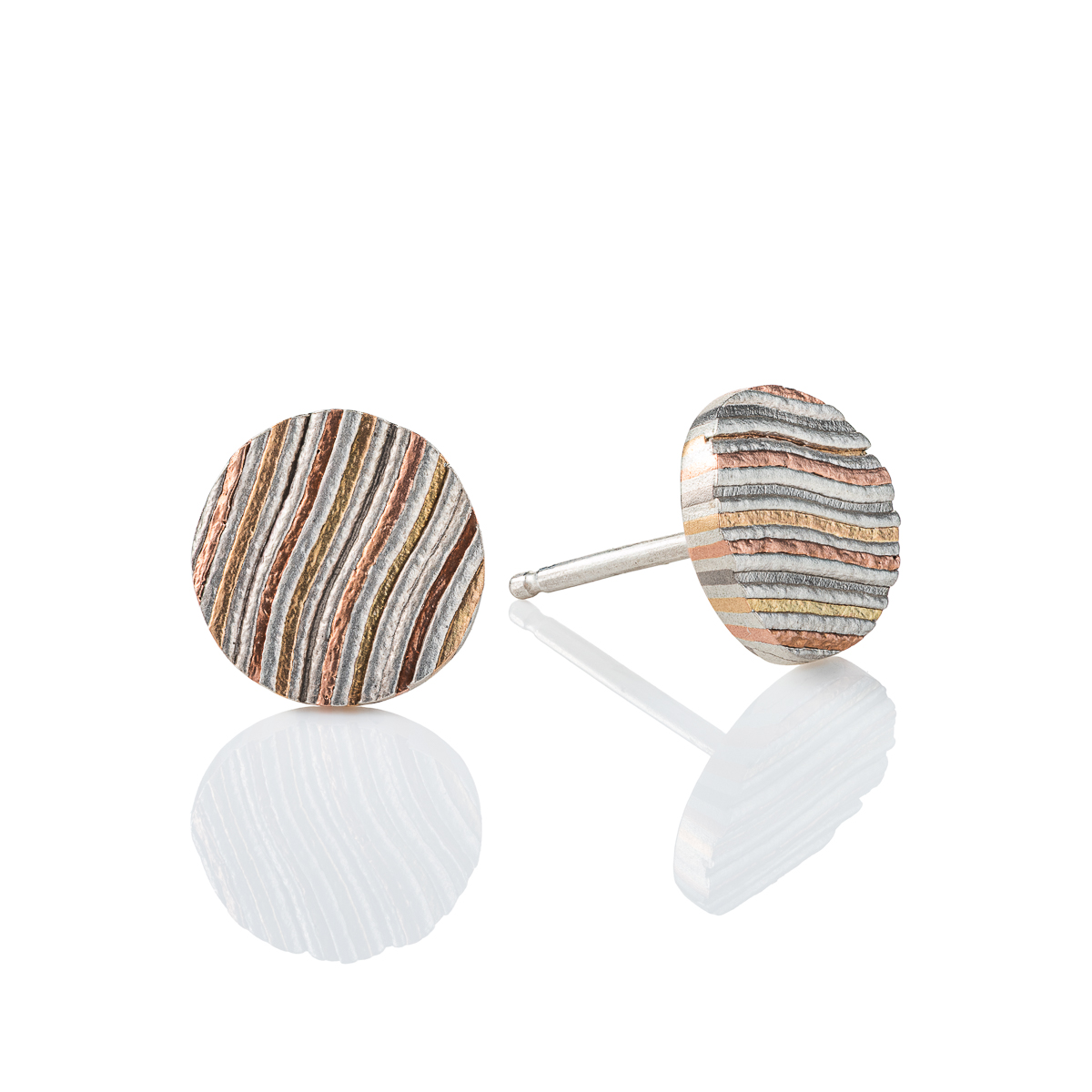striped mokume gane stud earrings are made in our Firestorm palette, featuring 14kt red gold, 14kt yellow gold, palladium, and silver. They feature an etched finish and added texture for a rustic feel.