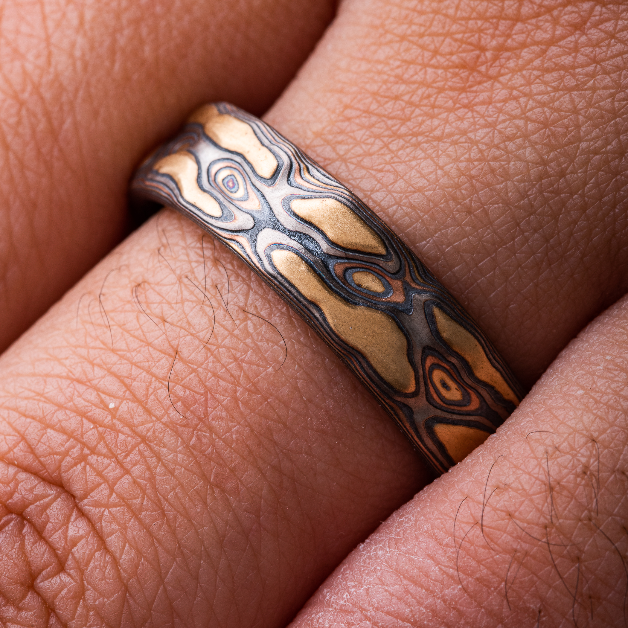 This 6mm Mokume Gane ring in Guri Bori style has a unique tactile beauty with swirling patterns in the Firestorm metal combination.
